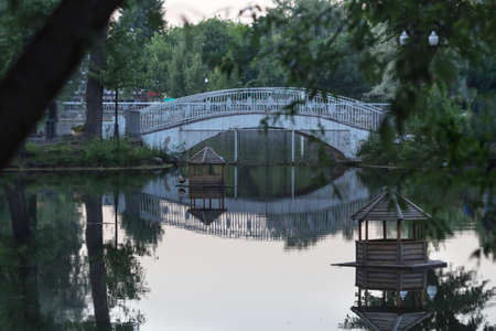 Beauty openwork bridge over water at duskの写真素材