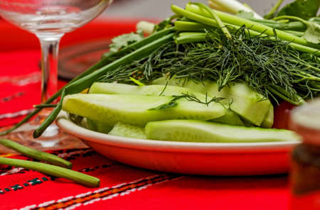 Fresh cucumbers and herbs on festive tableの写真素材
