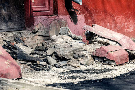 Part of ruins of old house in gray and red at sunny day