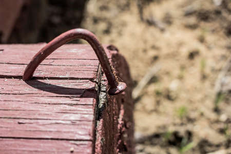 Bent nail driven into block of wood on sunny dayの写真素材