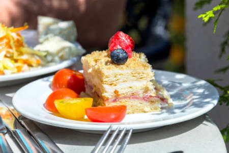 Fresh delicious piece of cake on saucer sunny dayの写真素材