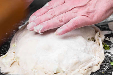 Hand to prepare dough for big pie