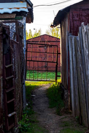 Metal gate between garages like symbol of future