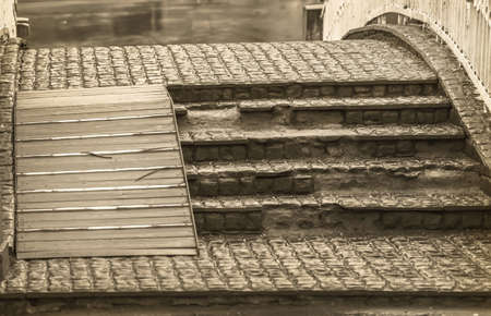 Small stone bridge with wooden deck in sepiaの写真素材