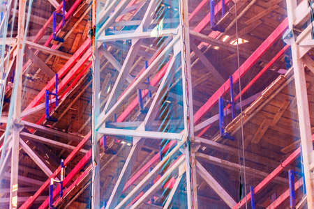 Scaffolding for workers covered by mesh at dayの写真素材