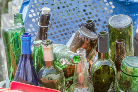 Dusty old empty bottles from alcohol at dayの写真素材