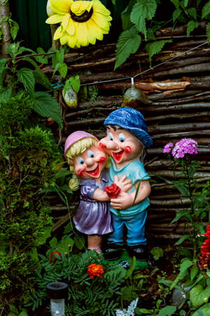 Nice decorative figurines of jolly fellows couple in summer gardenの写真素材