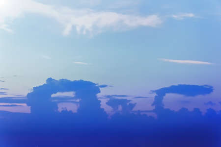 Blue purple sky after sunset over sea with mystic clouds
