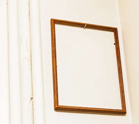 Big empty wooden frame on white wallの写真素材