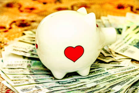 White piggy bank and many russian rublesの写真素材