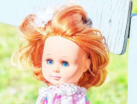 Pretty doll with red hair at sunny summer dayの写真素材