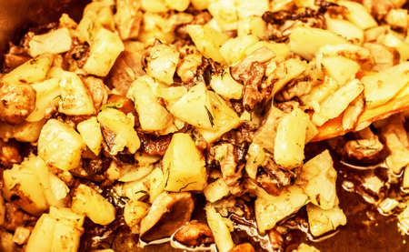 Fresh roasted potatoes with mushroom in kitchen bowl