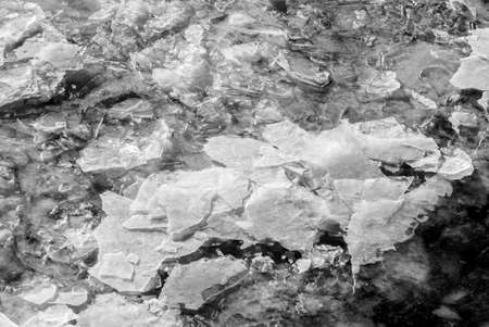 Beauty ice in dark water in winter clear day in black and white coloursの写真素材