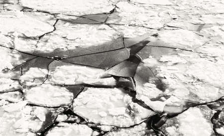 Big ices in dark winter water in black and white