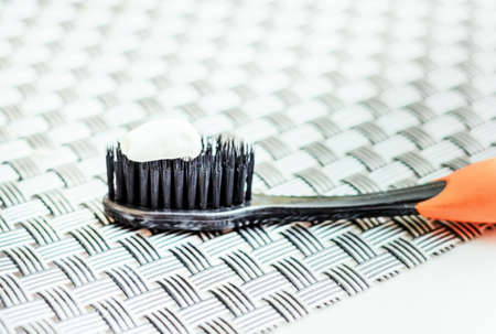 White toothpaste on black toothbrush for hygienne