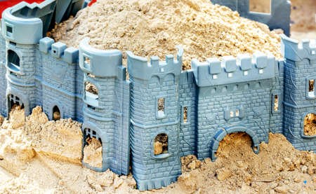 Toy fortress in children's sandbox at sunny day