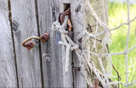 Old wooden fence with old handle and lockの写真素材