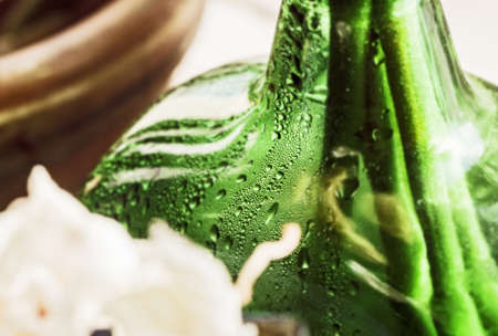 Drops of witer in green bottle at dayの写真素材