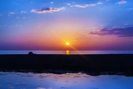 Beauty setting sun over sea multicolour horizonの写真素材
