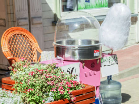 Machine with cotton candy at sunny day in streetの写真素材