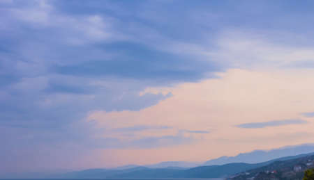 Great purple and pink sunset sky over mountainsの写真素材