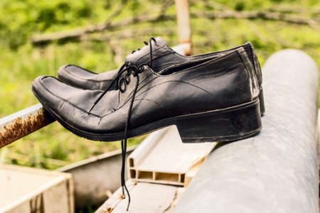 Old black men shoes like symbol of time and pastの写真素材