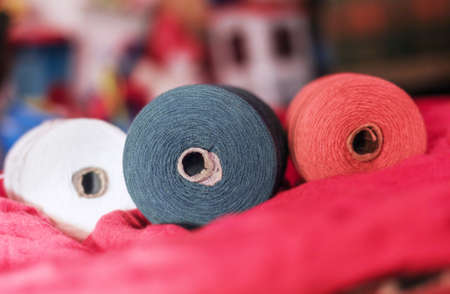 Spools of white, black and red thread