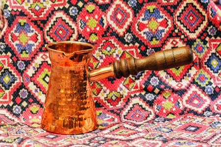 Beauty copper turk for coffee on multicolour backgroundの写真素材