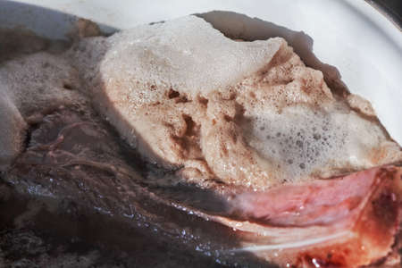 Big lush light foam when cooking meatの写真素材