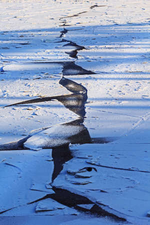 Crew geometric crack in ice at sunny winter dayの写真素材