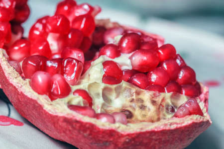 Red ripe grains in half of pomegranateの写真素材
