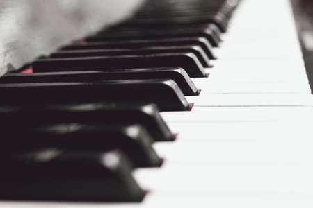 Close up piano keys black and white in light soft milk sepiaの写真素材