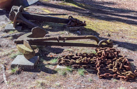 Old anchors on ground at sunny spring dayの写真素材