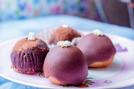 Fresh pretty chocolate topped cakes for tasty breakfast