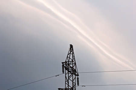 Iron electric tower on background of pre-storm sky