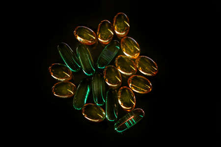 Real transparent pills on black background for good health and moodの写真素材