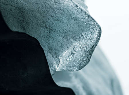Real pretty block of transparent ice on roof at winter dayの写真素材