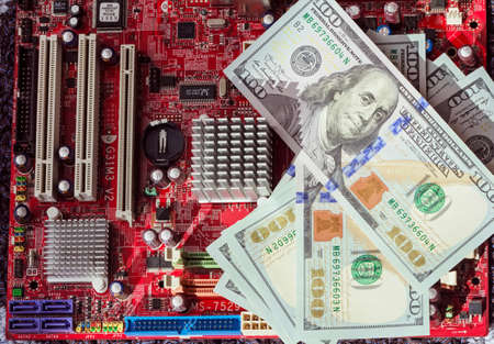 Real multicolor computer motherboard and dollar bills for real momentの写真素材