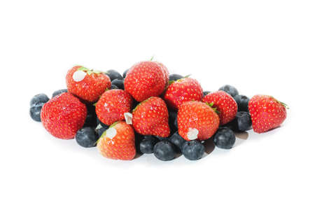 Ripe fresh tasty pretty strawberries and blueberries isolation on whiteの写真素材