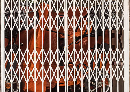 White closed modern metal lattice gates at day for keeping things
