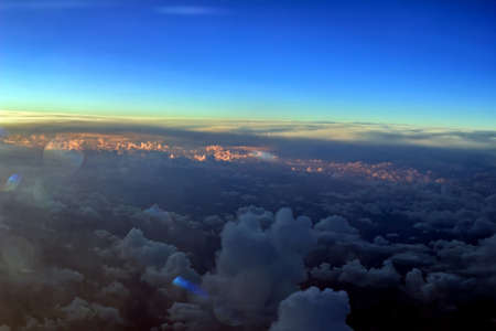 Pretty multicolored clouds from airplane window for good mood and inspirationの写真素材