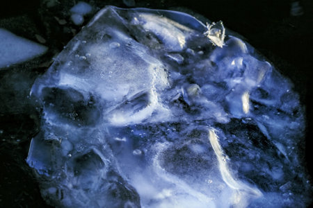 Real great huge blue ice floe in dark water in winter