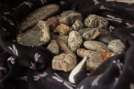 Real charming bunch of sea stones in scarf for fantasy momentsの写真素材