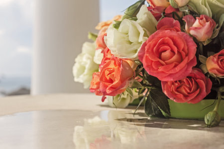 Real pretty bouquet of white and scarlet roses and eustoma on bright sunny backgroundの写真素材