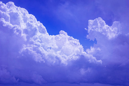 Real pretty white lush clouds in high blue sunny sky