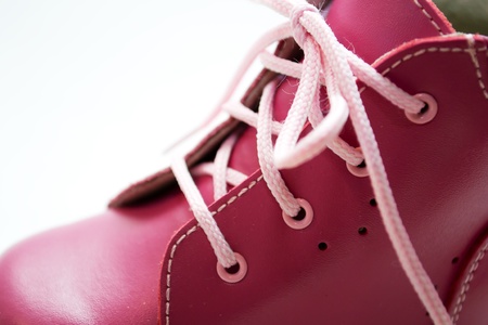 pink baby shoes on a white backgroundの写真素材