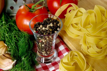 Ingredients for cooking pasta with tomatoes and herbsの写真素材