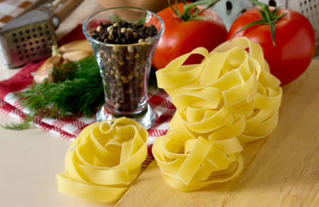 Ingredients for cooking pasta with tomatoes and herbsの写真素材