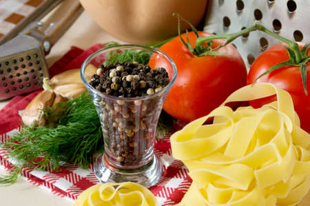 Ingredients for cooking pasta with tomatoes and herbsの写真素材