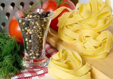 Ingredients for cooking pasta with tomatoes and herbsの写真素材